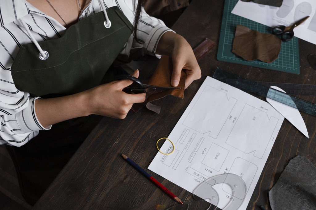 close-up-hands-cutting-textile